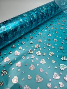 a roll of blue paper with lots of hearts on it