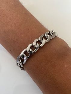 Welcome to my shop. Bold Silver Bracelet for everyone. Suitable from ages 10 to 100 years old. Clasp: Lobster Material: Stainless Steel. Chain: 13 x 10mm The Model in the photo is wearing a chain length of 8inches. This is a Custom order. If you have concerns about your skin colour and the gold colour, please agree with yourself first before buying. We don't know you nor are we magicians to know what shade of gold you like. Please message me for any enquiries.  Thank you 10mm Silver Curb Chain Bracelet, Chunky Chain Bracelet, Men Chain Link Bracelet, Stainless Steel Unisex Bracelet, Christmas Gift Silver Curb Chain Bracelets As Gifts, Silver Curb Chain Bracelets For Gift, Silver Cuban Link Chain Bracelet As A Gift, Vintage Silver Chain Bracelets, Silver Oval Link Cuban Bracelet For Gift, Vintage Silver Chain Bracelets As Gift, Cuban Link Metal Bracelet As Gift, Silver Chunky Chain Bracelet As Gift, Cuban Link Metal Bracelet For Gift