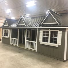 a small house with white trim and windows