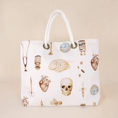 a white handbag with various medical items on the front and side, all over it