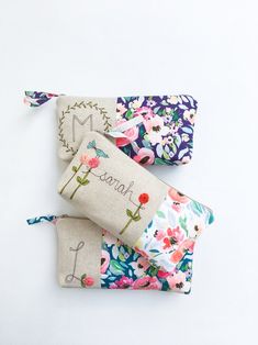 three small zippered pouches with flowers and the word mama written on one side