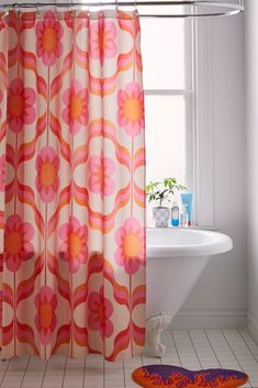 an orange and pink shower curtain in a bathroom