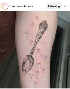 a tattoo with a spoon and stars on it