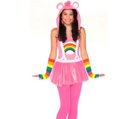 a woman wearing a pink costume with a rainbow bear on it's chest and ears