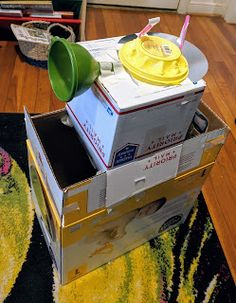 an open box on the floor with two cups in it