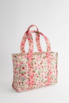 Our hero print of the season graces the Large Bonded Tote Bag by Cath Kidston. Strawberry Small is a classic hand-painted print showcasing sweet strawberries decorated with flowing florals and blooming blossoms. Designed with joyous detail, this delightful print coats the contrasting pink and ivory base, that perfectly celebrates the beauty of summer. Perfect as a work bag or for everyday use, this silhouette has a spacious main compartment and an internal pocket to store those easy access items Floral Purse, Sun With Sunglasses, Pink Floral Print, Eid Collection, Plus Size Shopping, Swimwear Cover Ups, Work Bag