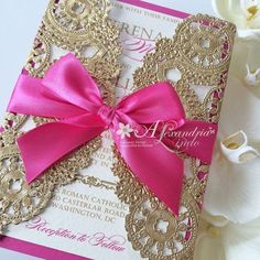 a pink and gold wedding card with a bow