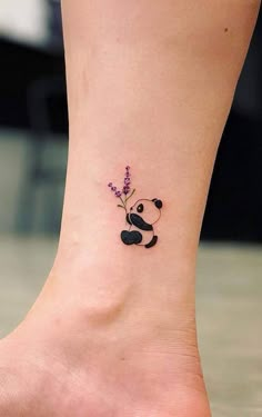 a small tattoo on the ankle of a woman with a panda bear and lavender flowers