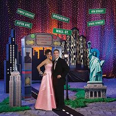 a man and woman standing in front of the statue of liberty