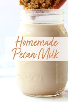 homemade pecan milk in a mason jar with a spoon full of granola on top