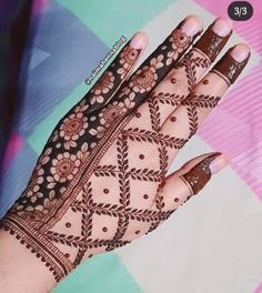 a woman's hand with henna tattoos on it