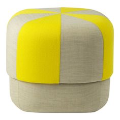 a yellow and grey ottoman sitting on top of a white floor