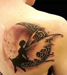 the back of a woman's shoulder with a fairy silhouette on it and stars