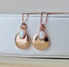 "A sweet new locket made with rose gold and an opal charm. Locket is rose gold plated and hangs from dainty rose gold plated chain. A small opal charm hangs off the side. See details and lengths below. * Locket - 13mm (1/2\") * Singapore chain -Adjusts to 18\" and 20\" only (has small ring to connect clasp at 18\" and 20\" lengths along chain) * Satellite Chain - Adjusts from 16-18\", or 18-20\" * Opal charm - Lab created opal, 6x4mm Please choose desired chain style and length at checkout. List Gold Opal Necklace, Dainty Rose, Small Ring, Locket Pendant Necklace, Necklace Rose Gold, Necklace Rose, Small Rings, Opal Necklace, Rose Gold Necklace