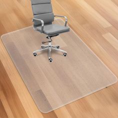 an office chair sitting on top of a rug in the middle of a wooden floor