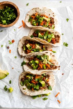 five tacos with meat, vegetables and lettuce