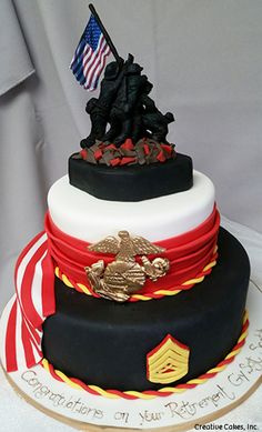 the cake is decorated with an american flag and two black soldiers on top of it