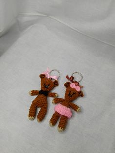 two crocheted teddy bears wearing pink dresses