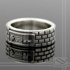 a ring that is made to look like an old computer gameboy video game controller