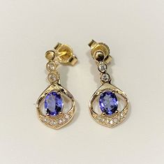 Vintage 14K Solid Yellow Gold Genuine Tanzanite & Diamond Earrings...Marked 14K...Total of weights 2.0grams...Measure H 5/8'' W 2/8''...These are in very good condition. Tanzanite Yellow Gold Earrings For Anniversary, Yellow Gold Tanzanite Earrings For Anniversary, Formal Gold Tanzanite Earrings, Tanzanite Diamond Earrings, Blue Sapphire Wedding Band, Sapphire Wedding Band, Tanzanite Diamond, Sapphire Wedding, Halo Pendant