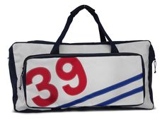 a white and blue duffel bag with the number 39 on it's side