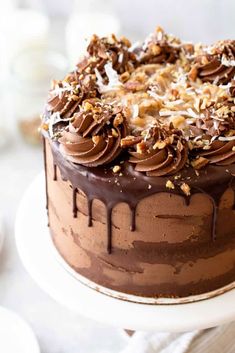 a chocolate cake topped with nuts and frosting