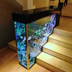 a fish tank sitting on top of a set of stairs