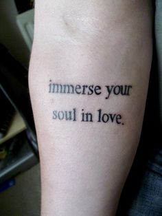 a person with a tattoo on their arm that says, immerse your soul in love