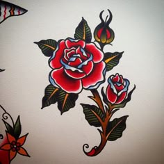 a rose tattoo on the side of a white wall with red and blue flowers painted on it