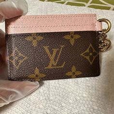 The Lv Charms Card Holder In Monogram Coated Canvas And Cowhide Leather Makes A Great Gift. Decorated With Two Gold-Color Monogram Blossom Charms, Its Clever Design Includes Five Card Slots: Two Slots On Each Side As Well As A Larger Compartment In The Middle. 4 X 2.9 X 0.1 Inches (Length X Height X Width) Rose Ballerine Pink Monogram Coated Canvas And Cowhide Leather Cowhide-Leather Lining Gold-Color Hardware 4 Outside Card Slots Large Inside Card Slot 2 Metallic Charms (Not Removable) Product Lv Card Holder, Louis Vuitton Wallet Women, Louis Vuitton Card Holder, 2025 Wishlist, Dream Wishlist, Pink Wallet, Purse Essentials, Pink Monogram, Cute Wallets