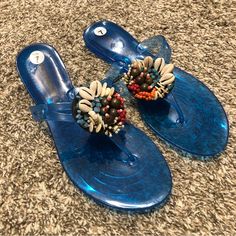 Avenue Blue Jelly Flip Flop Sandals Features Beautiful Shells And Bronze, White, Orange, Red And Turquoise Colored Beads Brand New Without Tags, No Box Does Have The Original Elastic And Security Tie Connecting The Flip Flop Sandals Together Size 7 M Are You New To Poshmark? Use My Code Taras_trunk13 To Sign Up & Get $10 Upon Joining With My Code. Blue Toe Post Sandals For Party, Blue Toe Post Party Sandals, Blue Embellished Sandals For Spring, Spring Embellished Blue Sandals, Spring Blue Embellished Sandals, Blue Beaded Adjustable Sandals, Flat Synthetic Sandals With Beaded Details, Blue Toe Post Sandals For Beach, Blue Beaded Open Toe Sandals