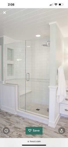 a bathroom with white cabinets and tile flooring in the shower area, along with a walk - in shower