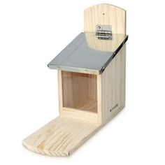 a wooden birdhouse with a metal roof and window on the outside, attached to a white background