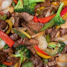 stir fry with beef, broccoli, peppers and onions in it on a plate