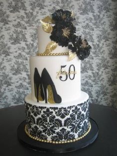 a 50th birthday cake decorated with high heels and flowers