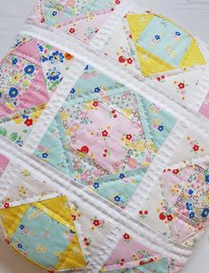 a close up of a patchwork quilt on a table