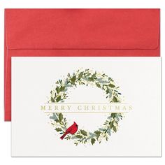 a christmas card with a red bird sitting on top of a holly wreath and merry christmas written across the front