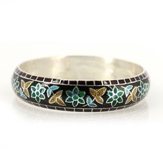 Flower Pattern Enamel Bangle for women, Floral Bangle, One of Kind Bangle, Top Trending Enamel Bangle, Meenakari Bangle from India, Product Details : Metal : 925 Solid Sterling Silver Designer Enamel Bangle inspired by nature. Bangle Width : 14 mm Approx Bangle Inner Diameter : 62 mm Approx Bangle Weight : 36.300 Grams Approx Style :  Enamel Jewelry  Note : All the enamel is hot enamel and purely handmade, if it falls from height there may be chance of breakage in enamel. All the designs are crafted by londonjewellers, its our original designs and mostly of them are ready in the stock, we are using Pure 925 (Stamped) Sterling Silver with Gemstones, our jewelry designs are Handmade. We are adding new creative designs in our shop regularly, for new handmade stuff please visit our shop : http Traditional Inlay Cuff Bangle Bracelet, Traditional Inlay Bracelets Perfect For Gifts, Traditional Inlay Bracelets As Gift, Traditional Adjustable Enamel Bracelets, Traditional Adjustable Inlay Bracelets, Traditional Flower Shaped Jewelry, Bohemian Silver Bracelets With Meenakari, Ceremonial Cuff Bracelet For Festivals, Bohemian Meenakari Bangle