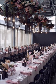 the tables are set up with pink and white linens for an elegant wedding reception