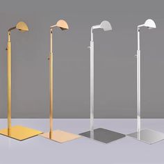 three floor lamps are shown in different shapes and sizes, one is gold the other is silver