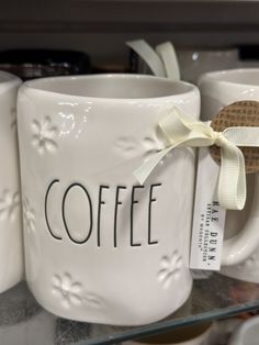 coffee mugs with bows are on display for sale