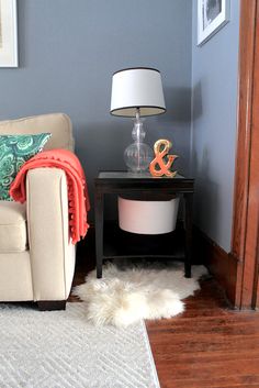 a living room with blue walls and a white rug on the floor next to a chair