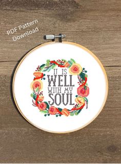 a cross stitch pattern with the words it is well with my soul in floral wreath