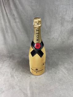 a bottle of champagne with a black ribbon around it