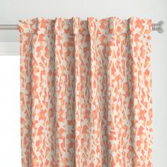 an orange and white curtain hanging from a window