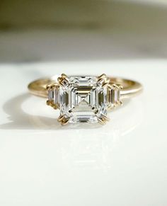 an engagement ring with three emerald cut diamonds