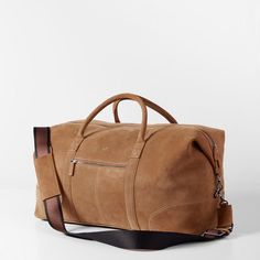 Impeccably crafted from high quality leather or suede, the Graham Leather Collection is filled with classic styles for work and travel. Designed with a place for everything you need for a weekend away, this overnighter features both carrying handles and an adjustable shoulder strap. Add a monogram to for a unique touch.    22"w x 9.75"d x 11"h  Made from leather or suede with a soft cotton lining.  Please see Product Information for more details.  Made in Turkey.  Camel: Monogramming is foil or blind debossed.  Chocolate: Monogramming is foil debossed. Luxury Cognac Weekender Bag For Everyday, Modern Suede Satchel For Travel, Modern Suede Shoulder Bag For Travel, Classic Suede Bag With Adjustable Strap, Brown Business Bag With Suede Lining, Camel Travel Bag With Leather Lining, Classic Luggage With Leather Trim For Daily Use, Elegant Suede Satchel For Travel, Travel Bag With Leather Lining In Camel Color