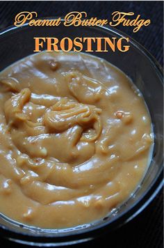 a glass bowl filled with frosting on top of a table