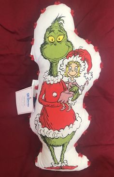 the grinch pillow is on display for sale