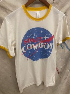 Country Deep Space Cowboy 70's ringer Unisex Tee Tri blend unisex T shirt 4.3 oz. 60% Cotton/40% Poly Vintage Space Tshirt, Unisex White T-shirt With Pop Culture Style, White Unisex Pop Culture T-shirt, White Pop Culture Unisex T-shirt, Unisex Retro Summer T-shirt, Retro Crew Neck T-shirt With Screen Print, White Retro T-shirt With Screen Print, Retro White T-shirt With Screen Print, Retro Pre-shrunk Crew Neck T-shirt